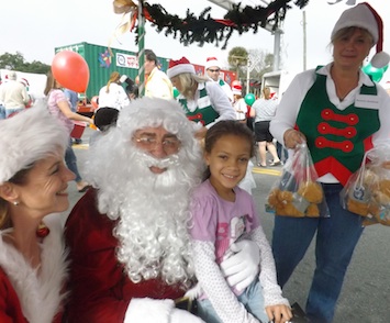 Santa talks with Nakya Jones during Toys for Tots stop in New Smyrna Beach